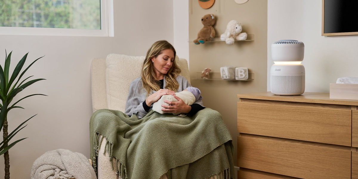 Woman holding baby in rocking chair