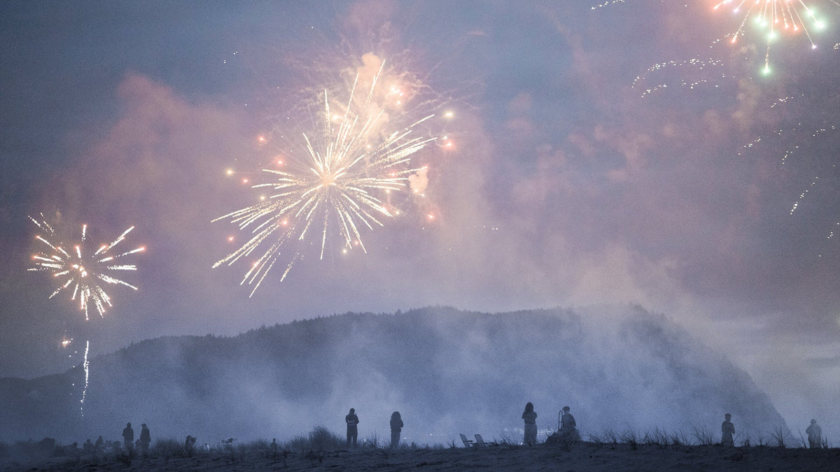 Smoky fireworks in the air over hills