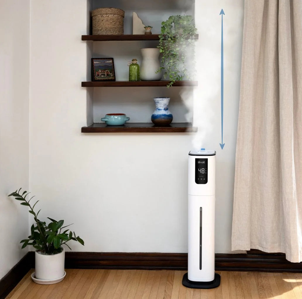 Levoit OasisMist 1000S ultrasonic tower humidifier releasing mist in living room, best humidifier for large room with wide coverage.