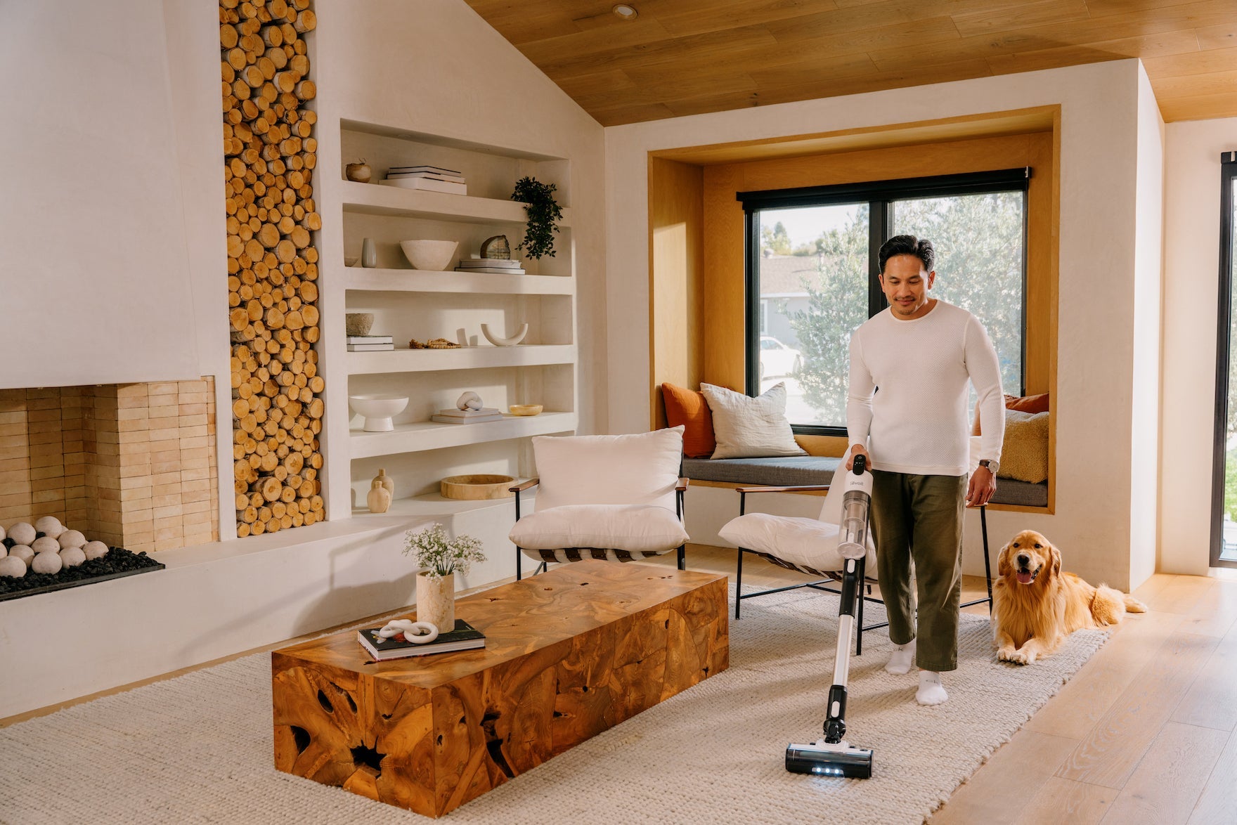 Man vacuuming rug in living room