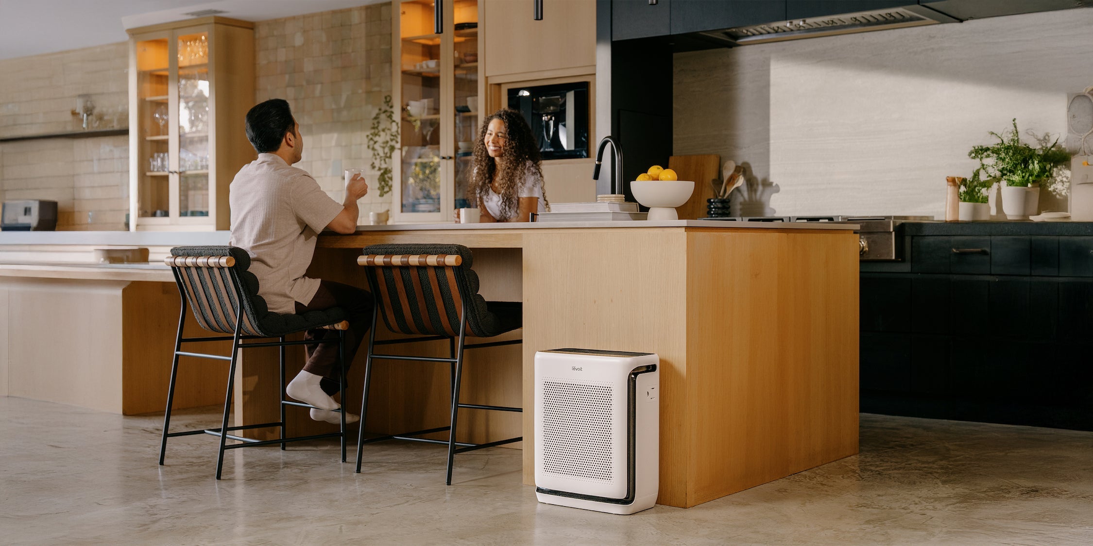 Man and woman in kitchen talking across kitchen island