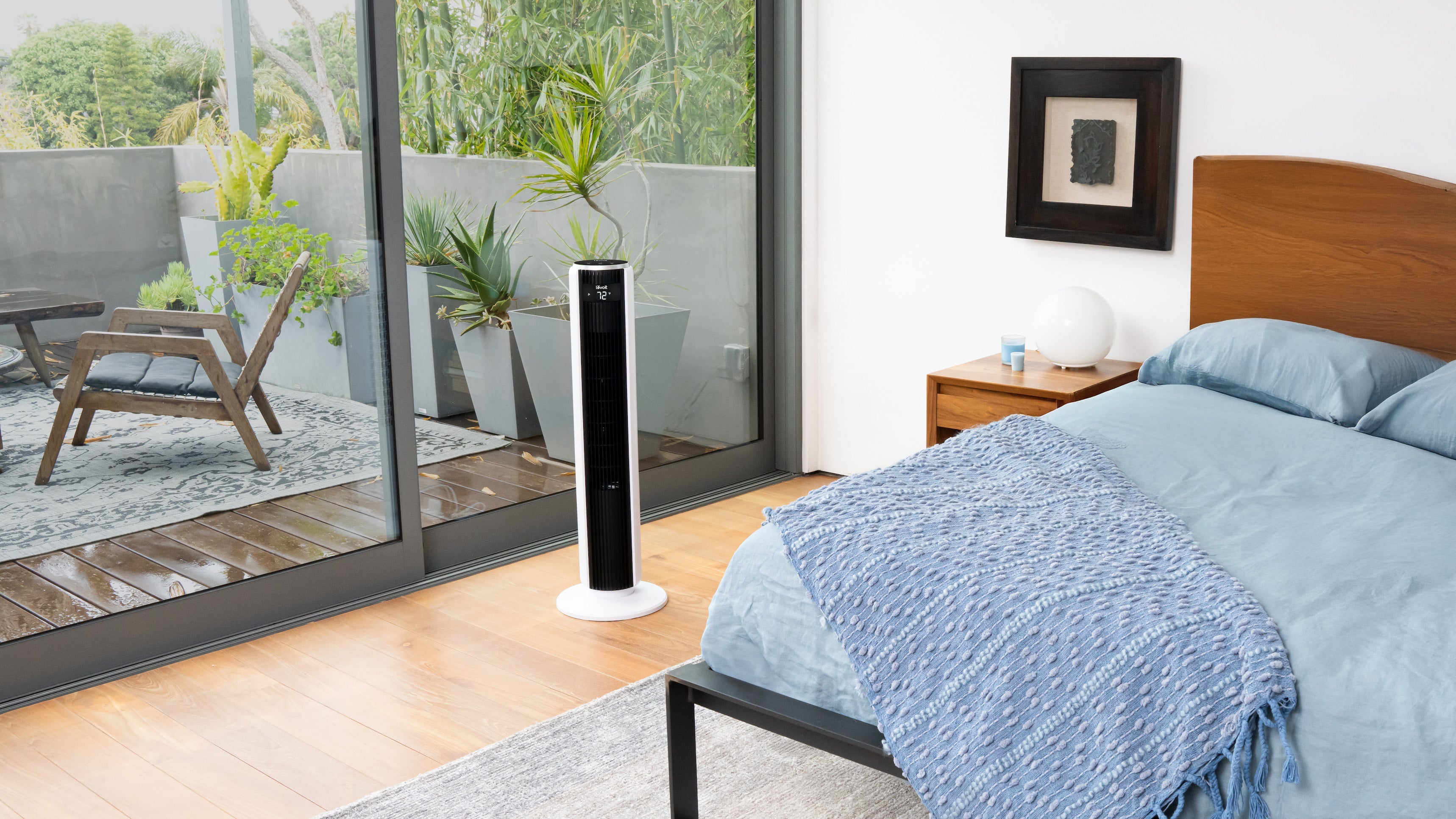 Tower fan next to bed