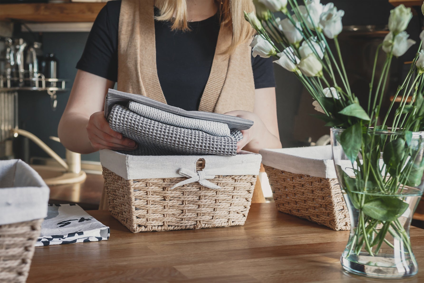 Woman organizing towels into baskets